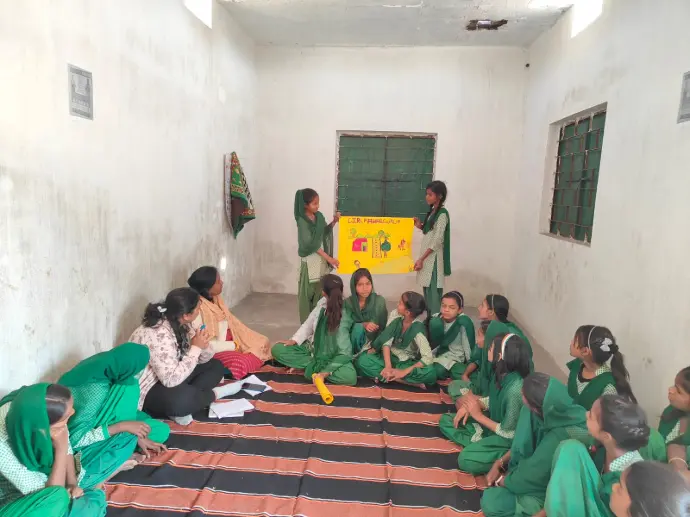 Menstrual Hygiene Awareness Program. Women and girls holding posters promoting menstrual hygiene awareness.
