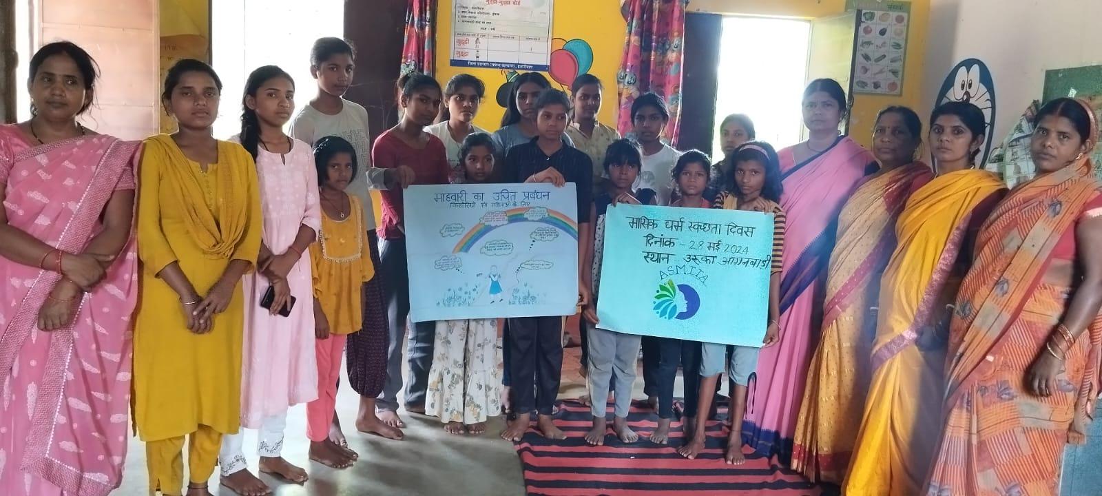Empowering women and children through education. A group of women and children engaged in a discussion inside a classroom.